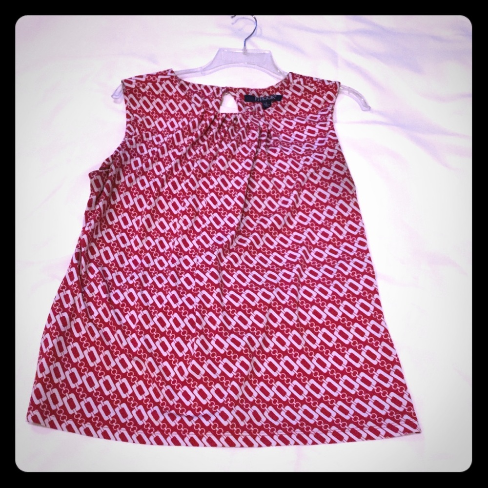 Red and white or black and white sleeveless top.